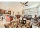 Open-concept living area featuring a ceiling fan, comfortable seating, and seamless flow to the kitchen at 26828 W Piute Ave, Buckeye, AZ 85396
