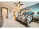 Stylish bedroom featuring accent wall, plush bedding, and ensuite bathroom at 26828 W Piute Ave, Buckeye, AZ 85396