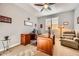 Bright home office featuring wood furniture, comfortable chair, and natural light from the window at 26828 W Piute Ave, Buckeye, AZ 85396