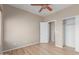 Bedroom features wood floors, closet, neutral walls, and an open doorway to a bathroom at 28933 N Saddle Way, San Tan Valley, AZ 85143