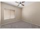 Neutral bedroom features a ceiling fan, carpet flooring, and a window to let natural light in at 28933 N Saddle Way, San Tan Valley, AZ 85143