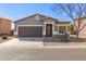 Charming single-story home with a well-manicured front yard and a two-car garage at 28933 N Saddle Way, San Tan Valley, AZ 85143