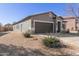 Well-maintained home exterior featuring desert landscaping, neutral tones, and an attached two-car garage at 28933 N Saddle Way, San Tan Valley, AZ 85143