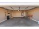Spacious garage with storage, work bench, and garage door leading outside at 28933 N Saddle Way, San Tan Valley, AZ 85143