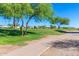 Golf course with mature trees and a walking path at 28933 N Saddle Way, San Tan Valley, AZ 85143