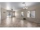 Open living room with tile and carpet, ceiling fan, and lots of natural light at 28933 N Saddle Way, San Tan Valley, AZ 85143