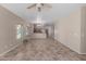 Bright living room showcasing tile flooring and an open layout to the kitchen at 28933 N Saddle Way, San Tan Valley, AZ 85143