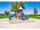 Colorful playground structure with slides and climbing area overlooking a pond at 28933 N Saddle Way, San Tan Valley, AZ 85143