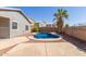 Backyard pool is surrounded by patio and a block fence for privacy at 28933 N Saddle Way, San Tan Valley, AZ 85143