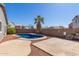Private backyard features a sparkling pool with a palm tree and ample patio space for outdoor living at 28933 N Saddle Way, San Tan Valley, AZ 85143