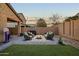 Relaxing backyard with patio seating area, string lights, a BBQ, and green grass at 3010 W Laredo Ln, Phoenix, AZ 85085