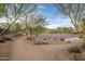 Community basketball court and playground nestled among trees, offering recreational opportunities for residents at 3010 W Laredo Ln, Phoenix, AZ 85085