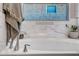 Bright, elegant bathroom with a free-standing tub, marble backsplash, and a modern faucet at 3010 W Laredo Ln, Phoenix, AZ 85085
