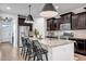 Kitchen island with granite countertops, seating, stainless steel appliances and modern pendants at 3010 W Laredo Ln, Phoenix, AZ 85085
