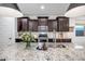 Stylish kitchen with a large granite island, stainless steel appliances and dark cabinetry at 3010 W Laredo Ln, Phoenix, AZ 85085