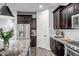 Kitchen with stainless steel refrigerator and appliances, granite counters and dark cabinets at 3010 W Laredo Ln, Phoenix, AZ 85085
