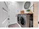 Well-organized laundry room with modern washer and dryer, white walls, and decor at 3010 W Laredo Ln, Phoenix, AZ 85085