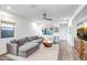 Bright living room features a comfortable sectional sofa and stylish decor with a ceiling fan at 3010 W Laredo Ln, Phoenix, AZ 85085