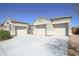 Attractive home showcasing a three-car garage, desert landscaping, and a secure gated courtyard at 30508 W Clarendon Ave, Buckeye, AZ 85396