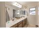 Bathroom features double vanity, framed mirrors, and neutral decor at 31106 N 138Th Ave, Peoria, AZ 85383