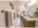 Bright bathroom featuring double sinks, granite countertops, and neutral tile flooring at 31106 N 138Th Ave, Peoria, AZ 85383