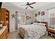 Bright bedroom with a floral bedspread and a ceiling fan, providing a relaxing and comfortable space at 31106 N 138Th Ave, Peoria, AZ 85383