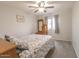 Carpeted bedroom features a bed, ceiling fan, and a dresser with decor at 31106 N 138Th Ave, Peoria, AZ 85383