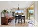 Dining room with backyard views, pendant lighting, piano, and sliding glass doors at 31106 N 138Th Ave, Peoria, AZ 85383