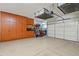 Spacious garage with ample storage cabinets and overhead racks for organization at 31106 N 138Th Ave, Peoria, AZ 85383