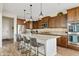 Kitchen with stainless appliances, dark wood cabinets, granite counters, and a breakfast bar at 31106 N 138Th Ave, Peoria, AZ 85383