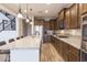 Spacious kitchen featuring stainless steel appliances, dark wood cabinetry, and a large island at 31106 N 138Th Ave, Peoria, AZ 85383