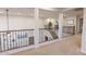 Second floor landing overlooking staircase with iron railing at 31106 N 138Th Ave, Peoria, AZ 85383