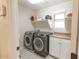 Convenient laundry room featuring a front-load washer and dryer, and storage at 31106 N 138Th Ave, Peoria, AZ 85383
