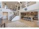 Spacious open floor plan with wood floors, staircase, and large kitchen with breakfast bar at 31106 N 138Th Ave, Peoria, AZ 85383