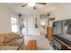 Living room with carpet, entertainment center, sofa, and guitars at 31106 N 138Th Ave, Peoria, AZ 85383