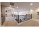 Bright loft area with views of the living area below and neutral carpeting at 31106 N 138Th Ave, Peoria, AZ 85383