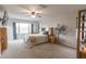 Spacious main bedroom with a large window, ceiling fan and closet at 31106 N 138Th Ave, Peoria, AZ 85383