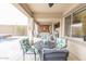 Covered patio with an outdoor seating area and a view of the backyard pool at 31106 N 138Th Ave, Peoria, AZ 85383