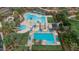 An aerial view of a community pool with slides, lap lanes, lounge areas, and fire pit at 31106 N 138Th Ave, Peoria, AZ 85383
