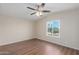 Bright, airy bedroom with wood floors, ceiling fan, and view to the exterior at 320 E Mckellips Rd # 166, Mesa, AZ 85201
