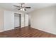 Bright bedroom featuring sliding closet doors, ceiling fan, and interior door at 320 E Mckellips Rd # 166, Mesa, AZ 85201