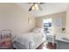 Bedroom featuring a ceiling fan, a window, and a bed with a pink and white comforter at 320 E Mckellips Rd # 166, Mesa, AZ 85201