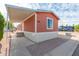 Exterior view of the home with a covered carport, tidy landscaping, and convenient access at 320 E Mckellips Rd # 166, Mesa, AZ 85201
