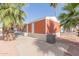 Exterior view of a home with desert landscaping, including mature palm trees at 320 E Mckellips Rd # 166, Mesa, AZ 85201