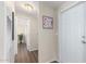 Hallway featuring a modern decor, a painting, and a white front door at 320 E Mckellips Rd # 166, Mesa, AZ 85201