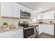 Updated kitchen featuring stainless appliances, granite counters, and white cabinets at 320 E Mckellips Rd # 166, Mesa, AZ 85201