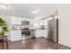 Modern kitchen with white cabinets, stainless steel appliances, and hardwood floors at 320 E Mckellips Rd # 166, Mesa, AZ 85201
