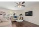 Well-lit living room showcasing modern furniture, hardwood floors, and a ceiling fan at 320 E Mckellips Rd # 166, Mesa, AZ 85201