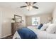 Cozy bedroom with ceiling fan, wood dresser and plush pillows at 320 E Mckellips Rd # 166, Mesa, AZ 85201