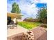 Backyard patio with a grill and outdoor furniture, adjacent to a spacious grassy area at 3227 E Enid Ave, Mesa, AZ 85204